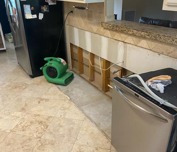 Kitchen with SERVPRO drying equipment on exposed cabinet wall