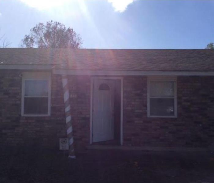 Brick home with the front door opened