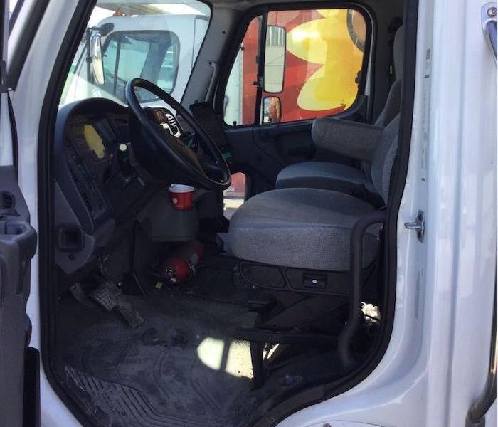 Open cab door on a commercial vehicle showing two seats