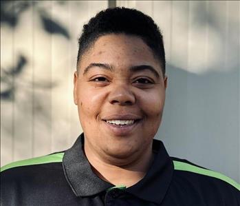 Markayla Farria, Restoration Technician, in a black SERVPRO HEROReady shirt standing in front of a white background