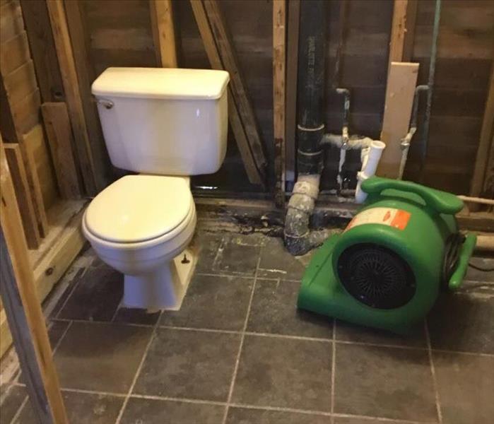 Bathroom with tile floor and framework exposed