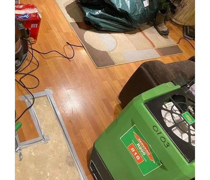  Wood floorboards with SERVPRO drying equipment and subfloor exposed