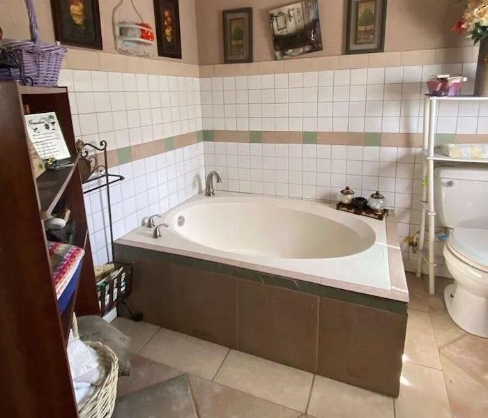 Round bathtub with smoke damage on the walls