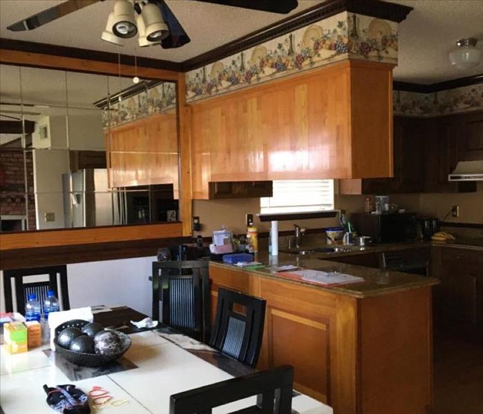 homes kitchen and dining room with wood cabinets