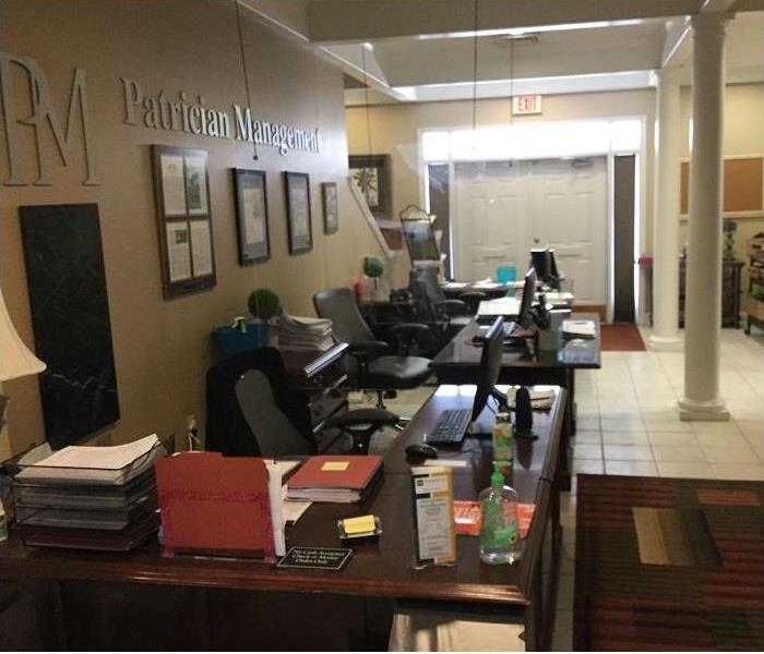 inside of office; several desks and chairs