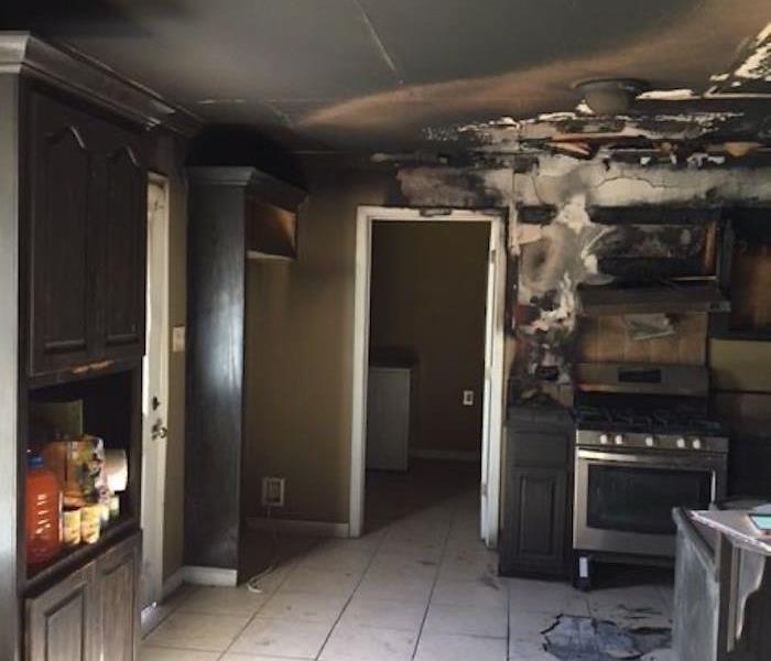  Kitchen with severe smoke and fire damage on walls and ceiling