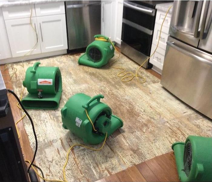 water damage equipment on a kitchen subfloor