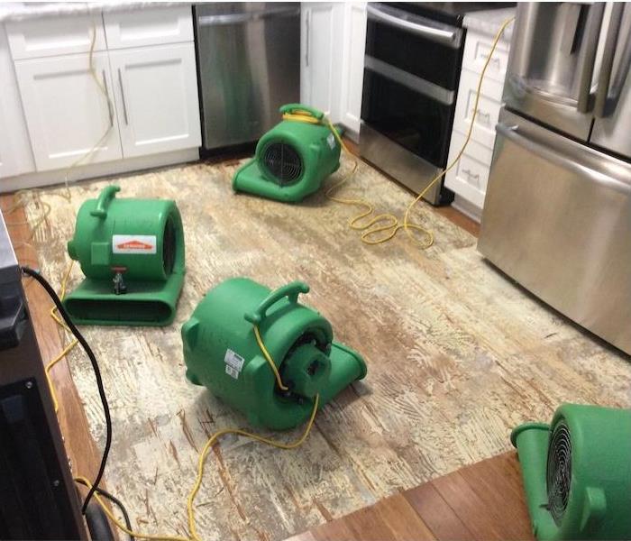 water damage equipment on a kitchen subfloor