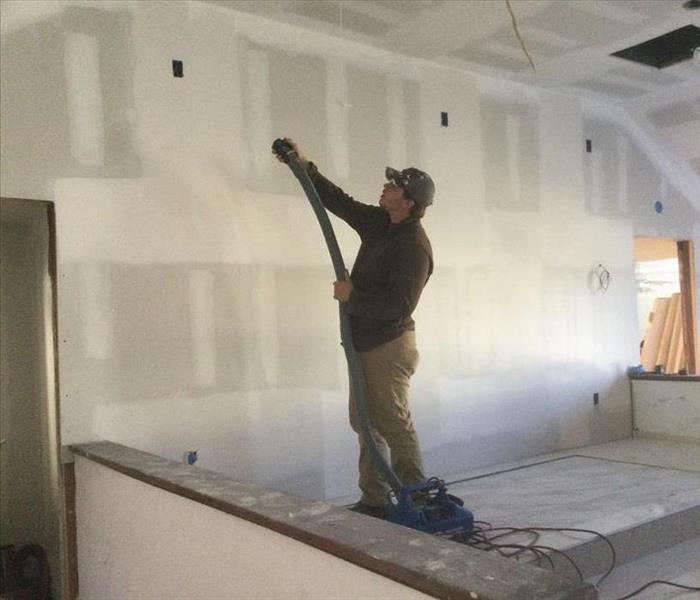 tech cleaning rebuilt drywall house