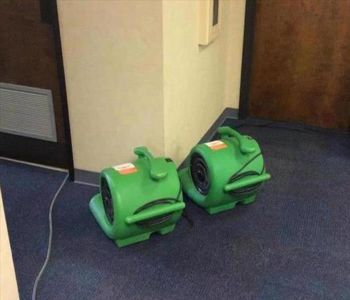 SERVPRO equipment working in a hall to remediate water damage