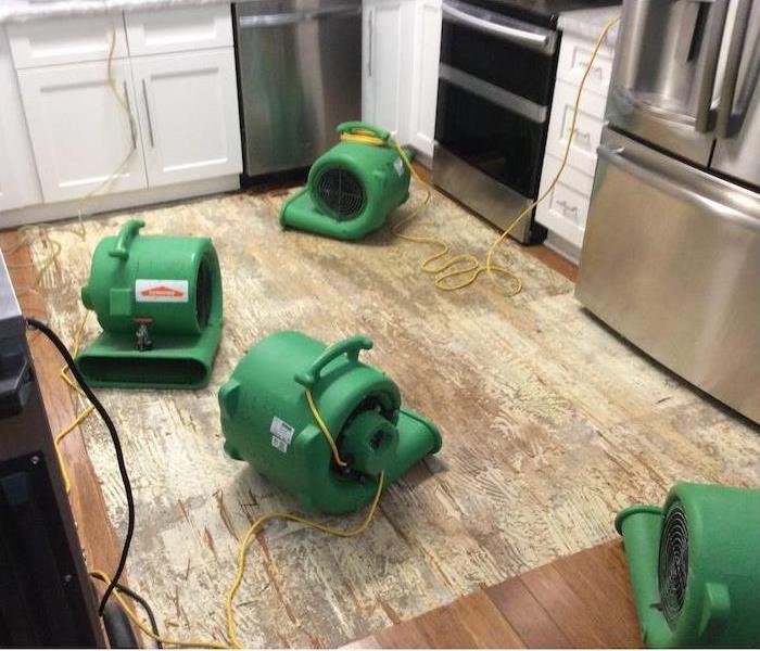 water damage equipment on a kitchen subfloor